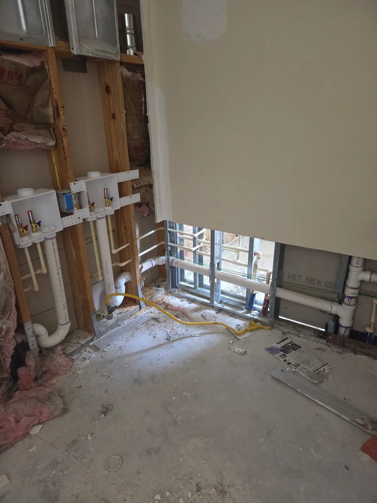 Floor drain rough-in with capped PVC in a bare concrete slab