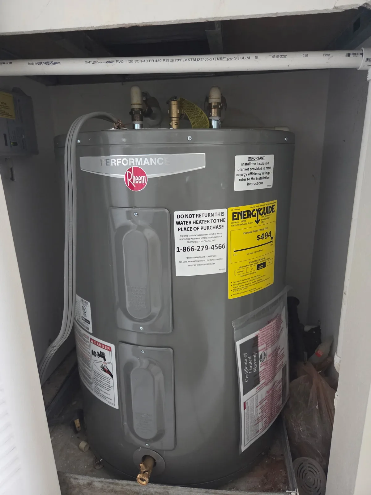 Rheem electric water heater installed in a residential closet